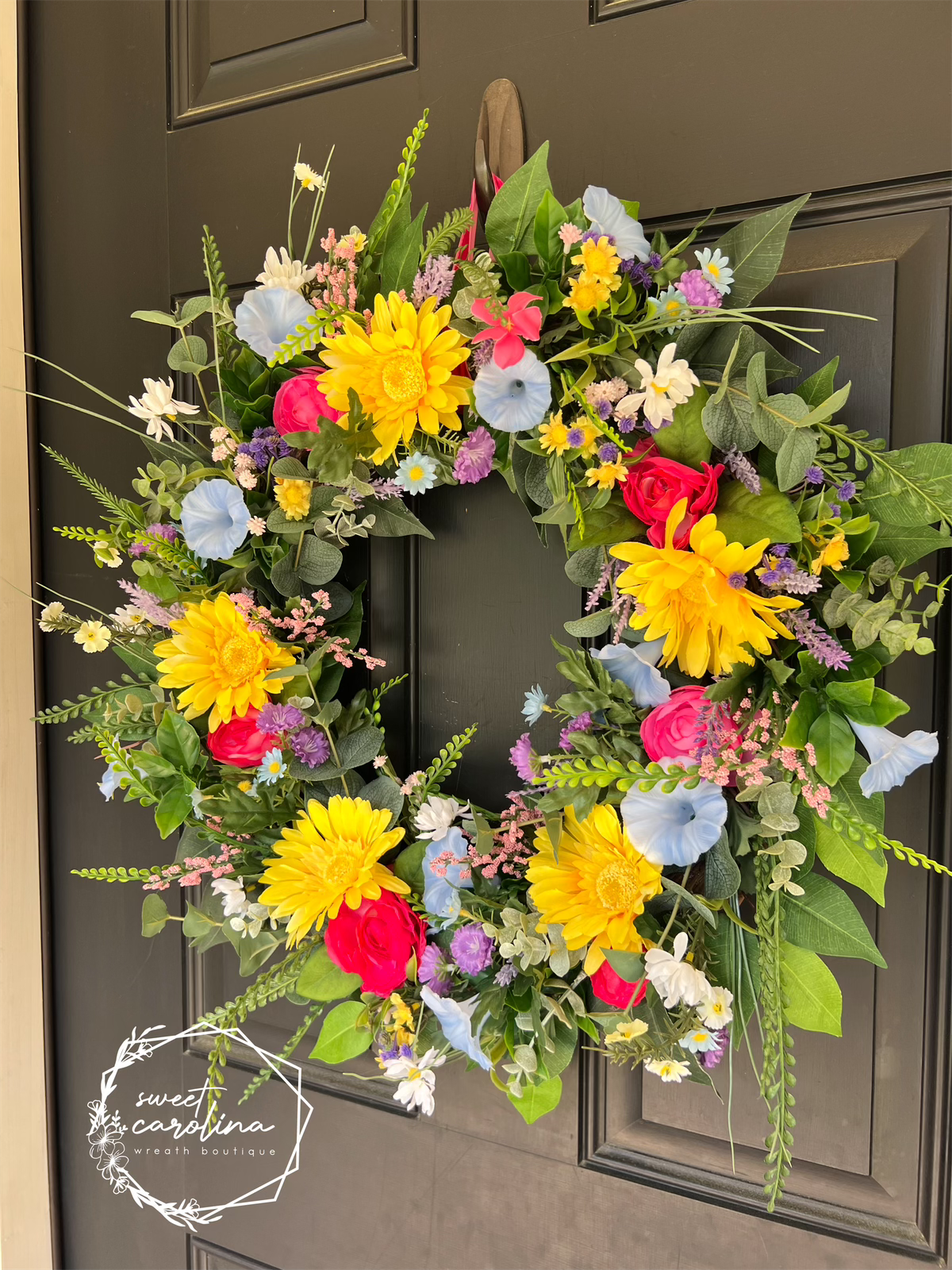 Bright Spring Wreath with daisies, petunias, and ranunculus