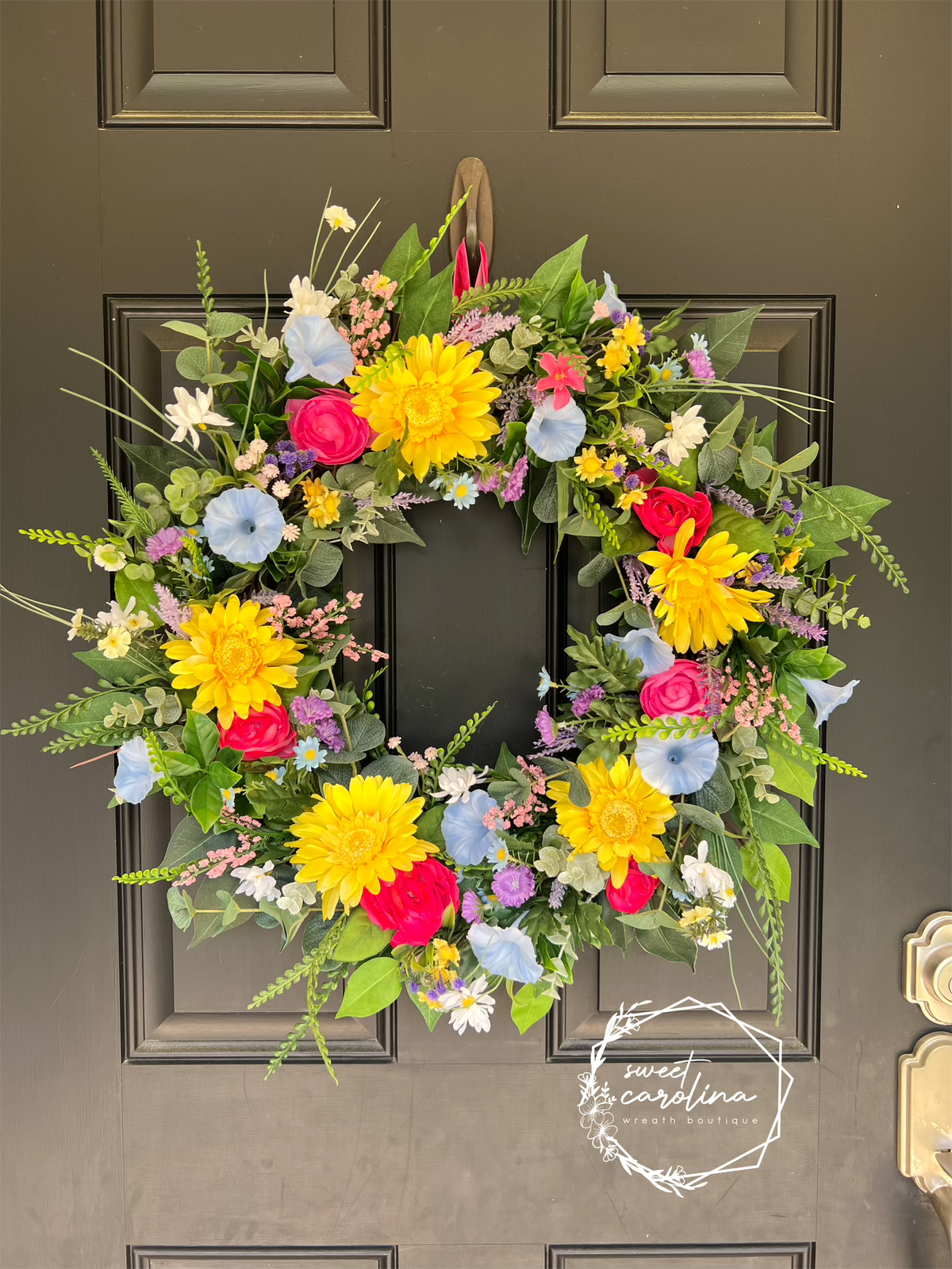 Bright Spring Wreath with daisies, petunias, and ranunculus